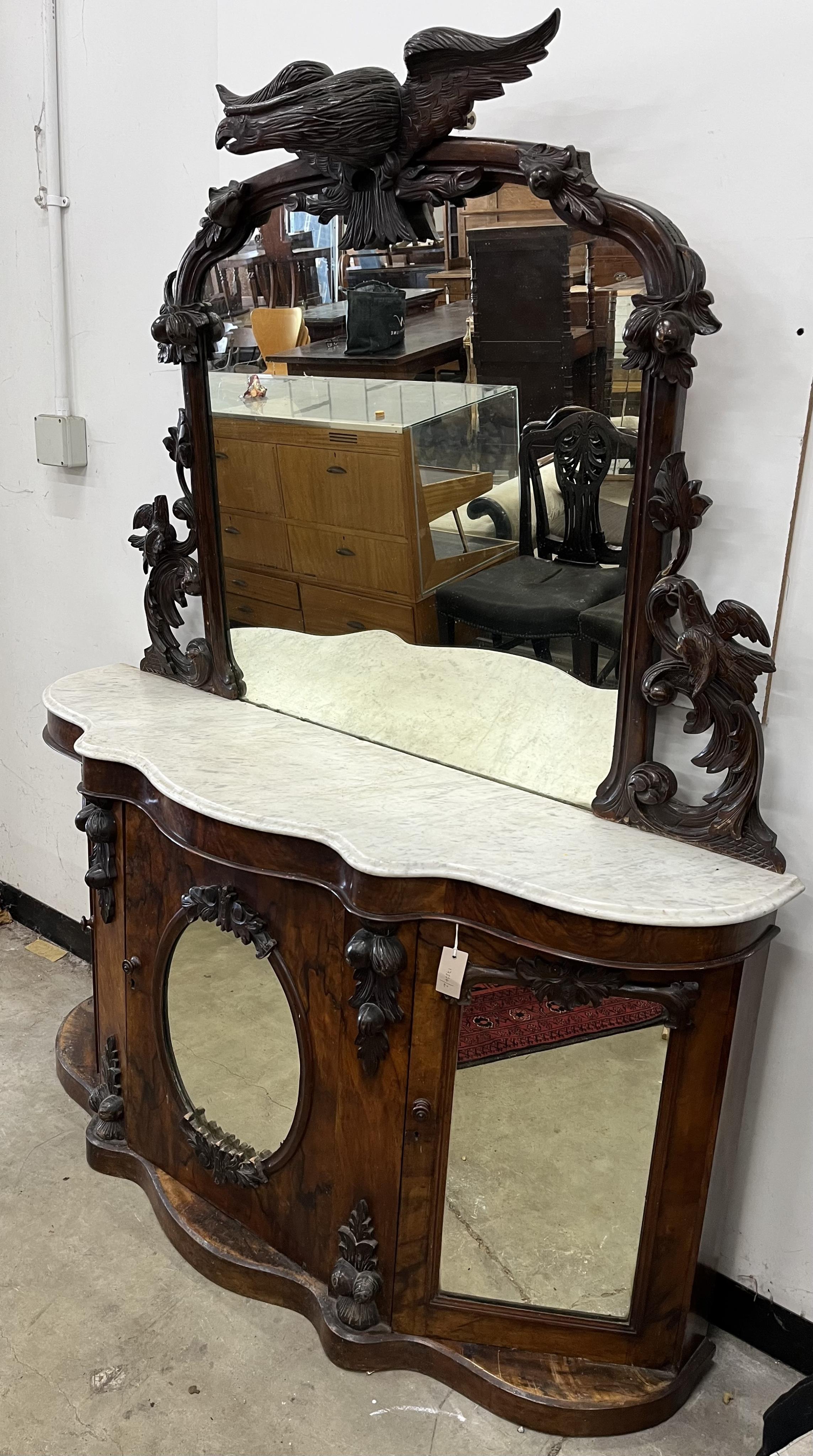 A Victorian walnut marble topped mirrored back credenza, mirror with eagle pediment, width 150cm, depth 43cm, height 125cm. Condition - poor to fair